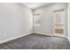 Interior view of a bedroom with carpet, a window and sliding glass doors leading to an outdoor balcony at 9125 Las Manaitas Ave # 302, Las Vegas, NV 89144
