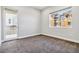 Neutral bedroom featuring carpeted floors, light grey walls, white trim and a window and a balcony sliding door at 9125 Las Manaitas Ave # 302, Las Vegas, NV 89144