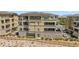 Exterior of a modern condominium, featuring multiple balconies, a secure fenced yard, and professional landscaping at 9125 Las Manaitas Ave # 302, Las Vegas, NV 89144