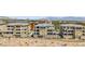 Exterior shot of upscale condominiums featuring multiple levels, neutral color schemes, and well-kept desert landscaping at 9125 Las Manaitas Ave # 302, Las Vegas, NV 89144