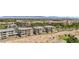 Aerial view of modern condominiums near a lush golf course, complemented by beautifully landscaped grounds at 9125 Las Manaitas Ave # 302, Las Vegas, NV 89144