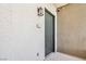 Neutral hallway featuring a dark door, apartment number, modern light fixture and security camera at 9125 Las Manaitas Ave # 302, Las Vegas, NV 89144