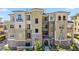 Multi-story condominium building with beige stucco exterior, balconies, and well-maintained landscaping at 9125 Las Manaitas Ave # 302, Las Vegas, NV 89144