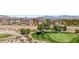 Beautiful golf course with manicured greens, desert vegetation, and luxury condominiums in the background at 9125 Las Manaitas Ave # 302, Las Vegas, NV 89144