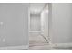 Interior view of the hallway featuring light gray walls, white trim, and doors with neutral colored hard wood floors at 9125 Las Manaitas Ave # 302, Las Vegas, NV 89144