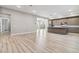 Open concept kitchen featuring modern cabinets, stainless steel appliances, hardwood floors and balcony access at 9125 Las Manaitas Ave # 302, Las Vegas, NV 89144