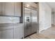 Stainless steel refrigerator integrated into the wood-grain kitchen cabinetry, complemented by modern backsplash at 9125 Las Manaitas Ave # 302, Las Vegas, NV 89144