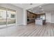 Open-concept kitchen features an island, sleek appliances, and access to a balcony at 9125 Las Manaitas Ave # 302, Las Vegas, NV 89144