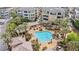 Stunning aerial view of the community pool with palm trees and rock features at 9125 Las Manaitas Ave # 302, Las Vegas, NV 89144
