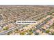 An aerial view showcasing a large neighborhood with uniform houses and well-maintained streets, featuring desert surroundings at 9362 Wilderness Glen Ave, Las Vegas, NV 89178