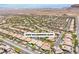 A panoramic aerial view of a sprawling residential community nestled against a backdrop of mountains and desert landscape at 9362 Wilderness Glen Ave, Las Vegas, NV 89178