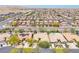 Wide aerial shot showcasing the neighborhood layout, nearby roads, and the desert landscape in the distance at 9362 Wilderness Glen Ave, Las Vegas, NV 89178