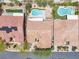 Aerial view of backyard pools, lush landscaping, and well-maintained properties in a quiet residential neighborhood at 9362 Wilderness Glen Ave, Las Vegas, NV 89178