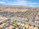 Scenic view of community featuring lush landscaping, pools, street, and desert mountains in the backdrop at 9362 Wilderness Glen Ave, Las Vegas, NV 89178