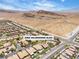 Scenic view of the community featuring pools, street, landscaping, and desert terrain in the background at 9362 Wilderness Glen Ave, Las Vegas, NV 89178