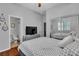 Bright bedroom with hardwood floors, TV, ceiling fan, and ensuite bathroom at 9362 Wilderness Glen Ave, Las Vegas, NV 89178
