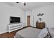 Bedroom featuring laminate flooring, a TV, decorative art, and a ceiling fan at 9362 Wilderness Glen Ave, Las Vegas, NV 89178