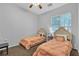 Bright bedroom features carpet, two beds with matching bedding, and natural light from a large window at 9362 Wilderness Glen Ave, Las Vegas, NV 89178
