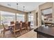 Bright dining area with large windows, comfortable seating, and seamless transition to living room at 9362 Wilderness Glen Ave, Las Vegas, NV 89178
