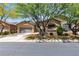 Charming single-story home featuring a well-maintained lawn, mature trees, and an attached two-car garage at 9362 Wilderness Glen Ave, Las Vegas, NV 89178