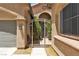 Close-up exterior shot featuring a charming side gate entrance with desert landscaping and architectural details at 9362 Wilderness Glen Ave, Las Vegas, NV 89178