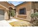 Close-up exterior shot featuring a charming side gate entrance with desert landscaping and architectural details at 9362 Wilderness Glen Ave, Las Vegas, NV 89178