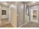 Hallway featuring neutral-colored walls, a wall fixture and arched doorways at 9362 Wilderness Glen Ave, Las Vegas, NV 89178