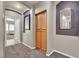 Inviting hallway with wood cabinet and decorative mirror leading to additional rooms in the home at 9362 Wilderness Glen Ave, Las Vegas, NV 89178