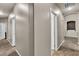 Neutral hallway featuring carpet, with arched doorway and access to multiple rooms in home at 9362 Wilderness Glen Ave, Las Vegas, NV 89178