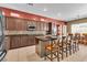 Modern kitchen with stainless steel appliances, a breakfast bar, and tiled backsplash at 9362 Wilderness Glen Ave, Las Vegas, NV 89178