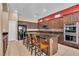 Spacious kitchen featuring a central island with seating and stainless steel appliances at 9362 Wilderness Glen Ave, Las Vegas, NV 89178