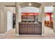 Stylish kitchen with dark wood cabinets, a central island, and a view into the dining area at 9362 Wilderness Glen Ave, Las Vegas, NV 89178