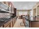 Spacious kitchen with stainless steel appliances, granite counters, and easy access to the dining area at 9362 Wilderness Glen Ave, Las Vegas, NV 89178