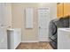Practical laundry area featuring a sink, storage cabinet, and modern appliances at 9362 Wilderness Glen Ave, Las Vegas, NV 89178