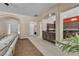 Open-concept living room leading to the kitchen with tile flooring and ample natural light at 9362 Wilderness Glen Ave, Las Vegas, NV 89178
