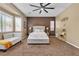 Bright main bedroom features accent wall, ceiling fan, and neutral carpeting at 9362 Wilderness Glen Ave, Las Vegas, NV 89178
