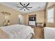 Comfortable main bedroom features ceiling fan, built-in tv nook, neutral carpeting, and bay window at 9362 Wilderness Glen Ave, Las Vegas, NV 89178