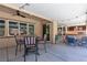 Covered patio featuring outdoor dining and relaxation areas with an outdoor grill, creating a comfortable outdoor living space at 9362 Wilderness Glen Ave, Las Vegas, NV 89178