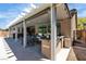 Covered patio features a hot tub, outdoor kitchen, ceiling fan, and lighting, perfect for entertaining at 9362 Wilderness Glen Ave, Las Vegas, NV 89178