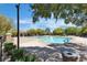 Community pool with sun loungers and shade, perfect for relaxation and recreation in a serene setting at 9362 Wilderness Glen Ave, Las Vegas, NV 89178