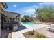 Pool with hot tub, patio area, landscaped yard, and seating, creating a relaxing outdoor oasis for enjoyment at 9362 Wilderness Glen Ave, Las Vegas, NV 89178