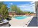 Backyard pool features well-maintained landscaping, privacy fence, and lounge chairs at 9362 Wilderness Glen Ave, Las Vegas, NV 89178