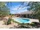 Backyard pool features well-maintained landscaping, patio and hot tub under covered area at 9362 Wilderness Glen Ave, Las Vegas, NV 89178