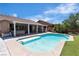 Backyard pool features well-maintained landscaping, privacy fence, and lounge chairs at 9362 Wilderness Glen Ave, Las Vegas, NV 89178