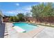 Bright shot of the pool featuring pristine water, concrete and stone edging, and surrounding trees in the backyard at 9362 Wilderness Glen Ave, Las Vegas, NV 89178