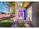 Charming covered back patio with dining set, overlooking a well-manicured lawn and garden area at 9704 Royal Lamb Dr, Las Vegas, NV 89145