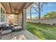 Covered back patio with seating area, ceiling fan, and a well-maintained lawn at 9704 Royal Lamb Dr, Las Vegas, NV 89145