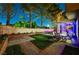 Well-manicured backyard with patio, string lights, and lush landscaping creating a serene retreat at 9704 Royal Lamb Dr, Las Vegas, NV 89145