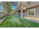 This property offers a spacious backyard featuring a covered patio, manicured lawn, balcony, and serene landscaping at 9704 Royal Lamb Dr, Las Vegas, NV 89145