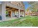 The backyard offers a lush lawn, covered patio, balcony, and space for outdoor relaxation and dining at 9704 Royal Lamb Dr, Las Vegas, NV 89145